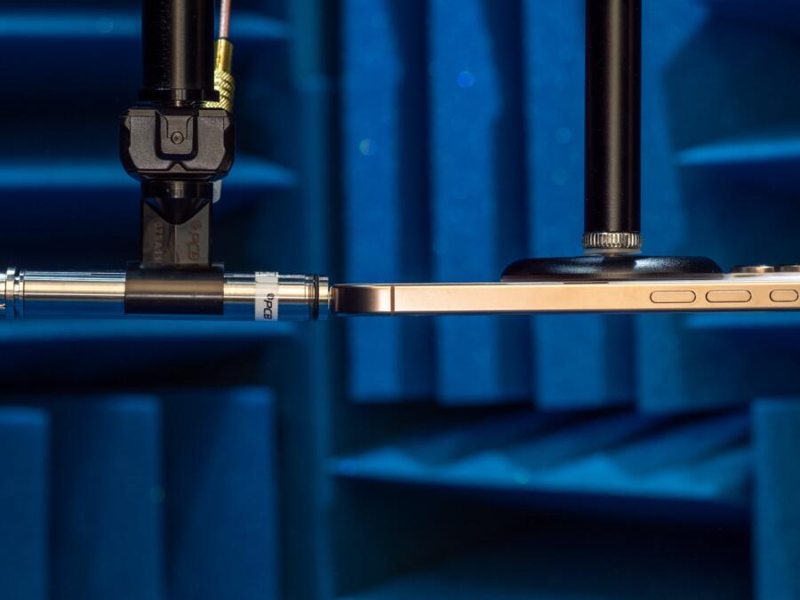 iPhone 16 Pro and PCB 378B02 positioned for frequency response measurement in an anechoic chamber.