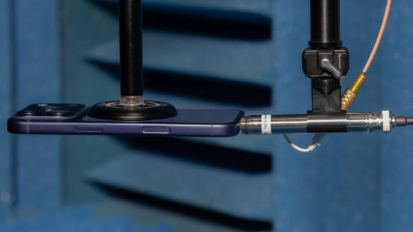 iPhone 17 Pro and PCB 378B02 positioned for frequency response measurement in an anechoic chamber.